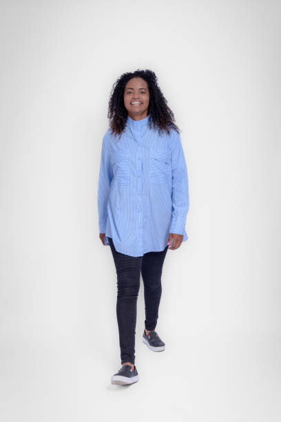 istock Portrait of woman walking forward in studio with gray background 1482324331