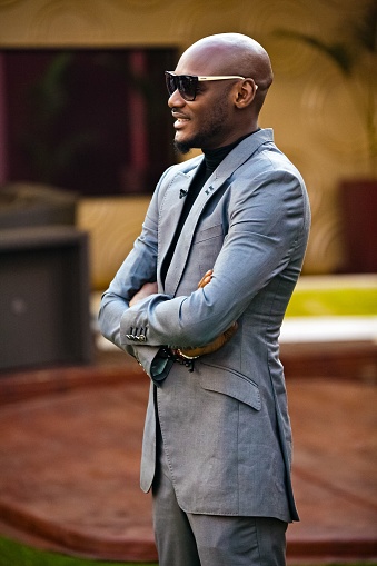 Johannesburg, South Africa – February 01, 2023: A mature African-American man wearing a fashionable grey suit and sunglasses standing with a confident and strong posture
