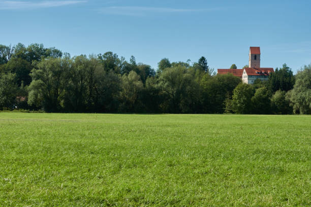 istock Church (Clemens kirche) on a small hill between green trees. Beautiful meadow in foreground. Copy space. 1482331271