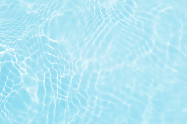 istock Defocus blurred transparent blue colored clear calm water surface texture with splashes and bubbles. Trendy abstract nature background. Water waves in sunlight with copy space. Blue water shine 1482331473