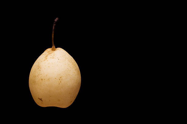 Yellow pear on black background stock photo