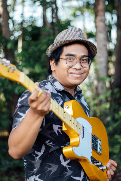 istock man playing his DIY yellow guitar 1482332698