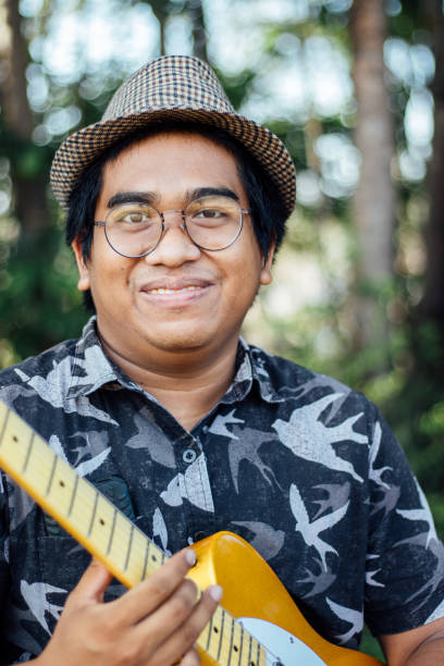 istock man playing his DIY yellow guitar 1482332699