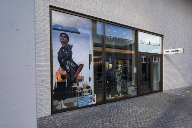 Karl Lagerfeld Outlet store. Bright exterior facade. Cobblestone in the foreground. Side view. Wide angle. Metzingen, Germany - March 20, 2021: Karl Lagerfeld Outlet store. Bright exterior facade. Cobblestone in the foreground. Side view. Wide angle. karl lagerfeld stock pictures, royalty-free photos & images