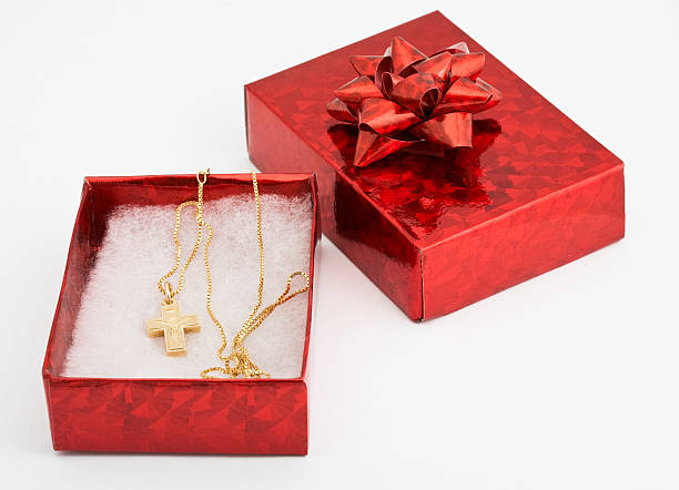 Red box with gold chain and cross within stock photo