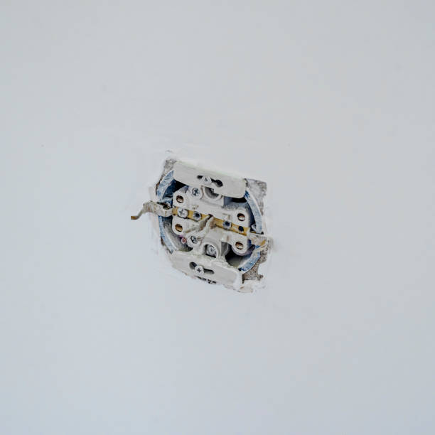 istock disassembled socket on the plastered wall. renovation and construction concept 1482336941