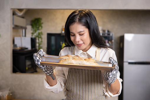 Female Asian Baker Smelled the Aroma ofFreshly Baked Breads