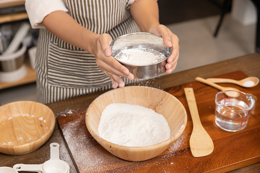 View of Woman Hand Sifting Bread Flour Before the Process of Kneading Dough