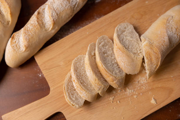 istock Cut baguette on wooden board 1482337201