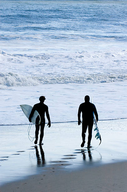 istock Two Surfers Walking Towards Ocean II 148233727