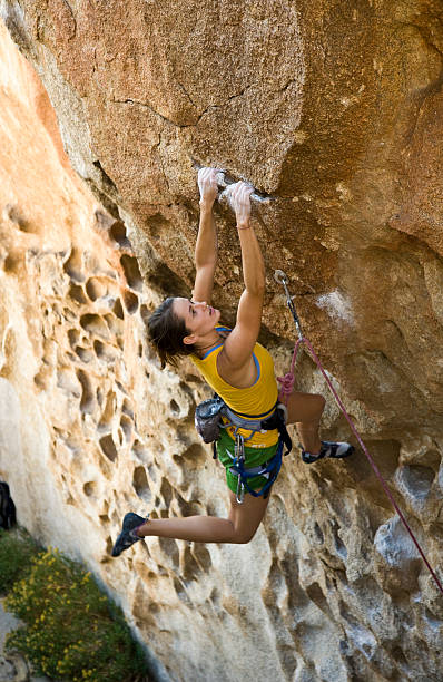 istock Female climber clinging to a cliff. 148233970