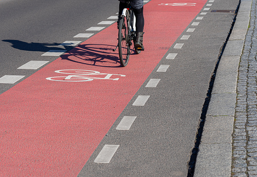 Low Section Of Person Riding Bicycle On Street, Berlin Zehlendorf