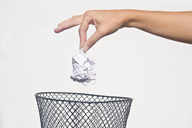 istock Hand disposing of rubbish in a trash can 148234195