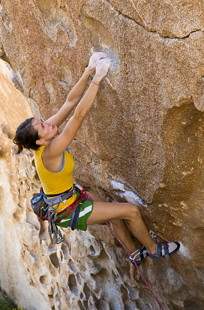 istock Female climber clinging to a cliff. 148234230