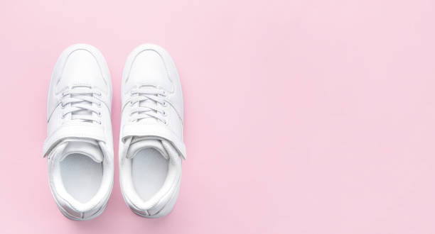 istock White sneakers on a pink background. 1482342899