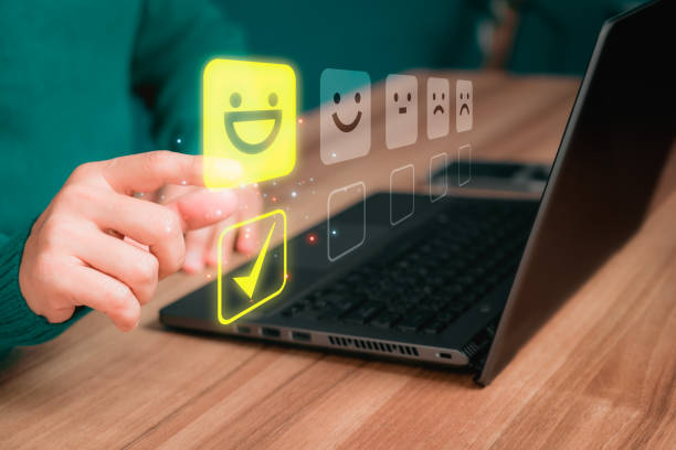 istock Man hand using computer laptop with popup five star icon for feedback review satisfaction service and testimonial. Customer service experience and business satisfaction survey. 1482345241