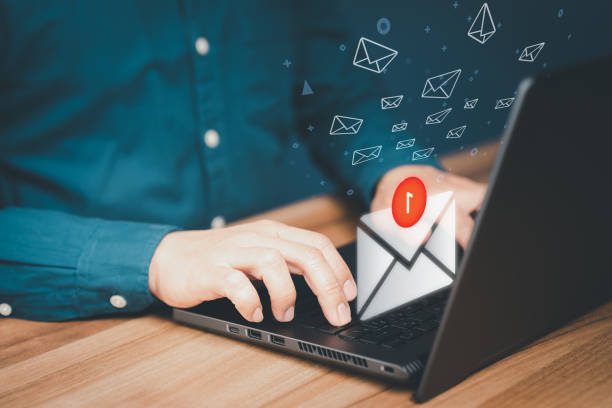 istock Man hand using a computer laptop and sending online message with email icon in the office. Concept of E-mail marketing and newsletters network, internet technology and life. 1482346474