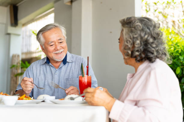 istock Asian senior couple having lunch together at restaurant. 1482346492