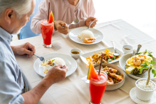 istock Asian senior couple having lunch together at restaurant. 1482346497
