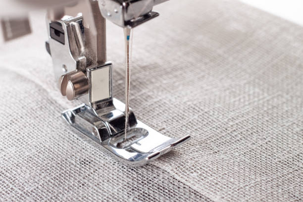 istock Modern sewing machine presser foot with linen fabric and thread, closeup 1482347685