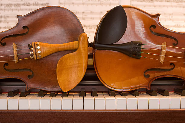 istock Two violins lying on a piano keyboard 148234984