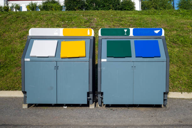 istock multicolored metal tanks for separate garbage. natural hard light 1482354727