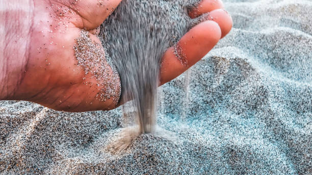 istock Man holding sand in his hands 1482358347