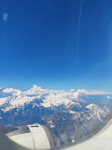 Mountain Peaks from Airplane Window | Aerial view