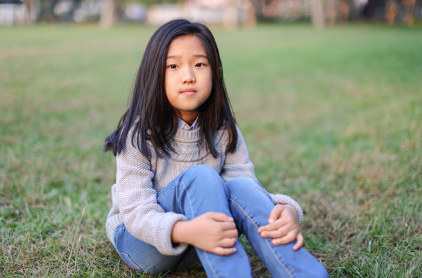 istock Little Girl Sitting on the Lawn 1482362434
