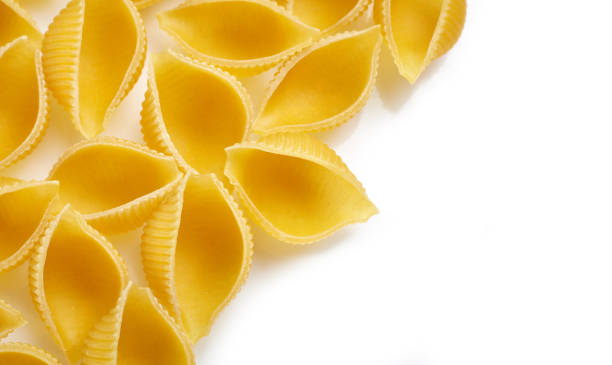 istock Classic durum wheat pasta isolated on white background. Food and drink concept - various uncooked pasta on white background. Variety of types and shapes of dry Italian pasta 1482364003