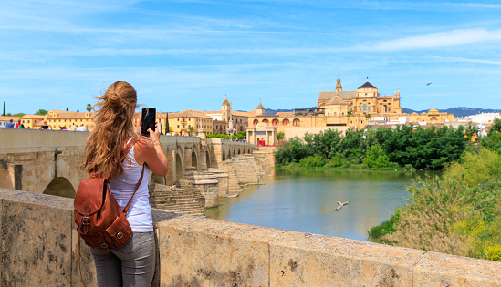 Woman tourist taking picture of Cordoba cathedral, Spain, andalusia