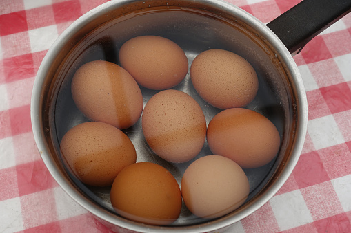 Eggs cooked in a pot of hot water