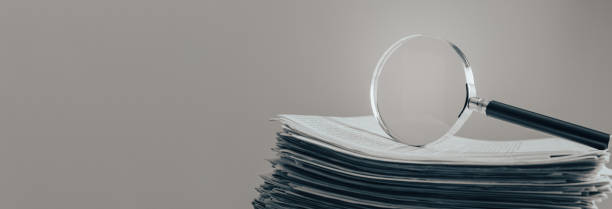 istock magnifir on newspaper 1482365141
