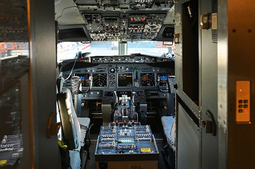 Barcelona, Spain – February 03, 2023: The interior cockpit of the  Boing 737 plane with a variety of large buttons and controls