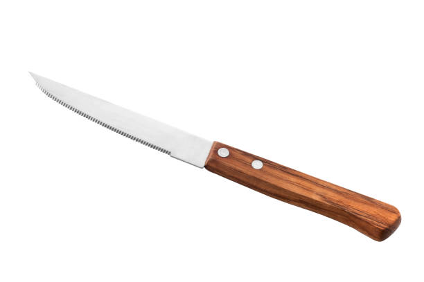 Serrated table knife Serrated table knife with wooden handle isolated on white, clipping path included dangerous steak stock pictures, royalty-free photos & images