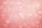 Defocused pink background with heart shapes