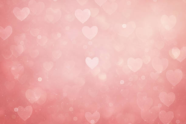 Defocused pink background with heart shapes - fotografia de stock