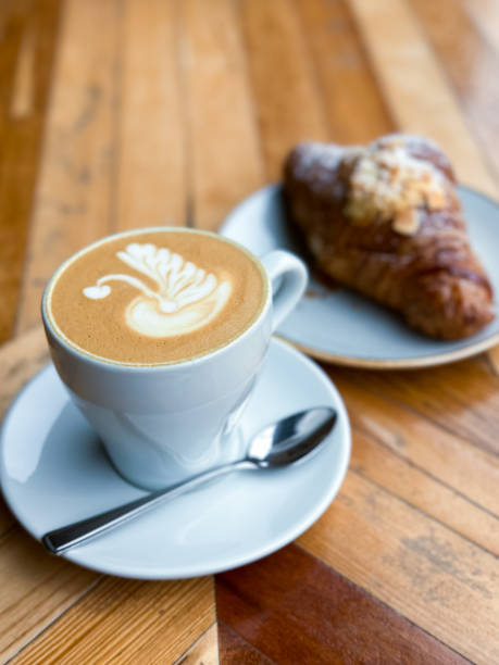 istock Cup of fresh flat white or latte coffee with croissant 1482371185