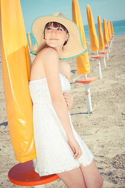 Young woman on a beach with hat stock photo