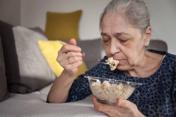istock Senior woman eating at home 1482372267