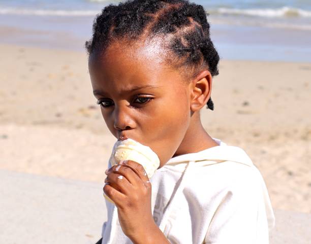 istock child eating ice-cream on the beach 1482373029