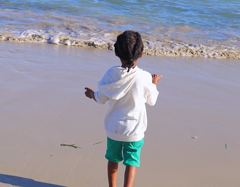 Black African child playing on the beach