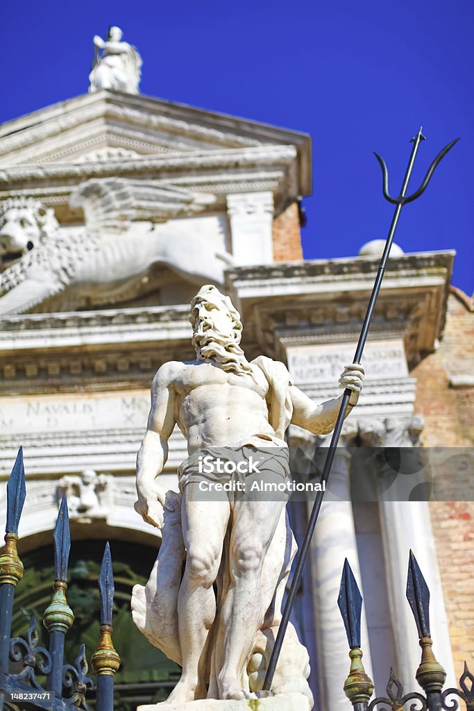 Neptune with trident close to Venetian arsenal Sculpture of Neptune with trident near to entrance to Venetian Arsenal, Italy Adult Stock Photo