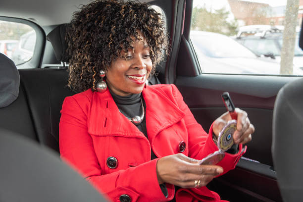 istock Pretty african american woman in car doing makeup while standing in a traffic 1482375498