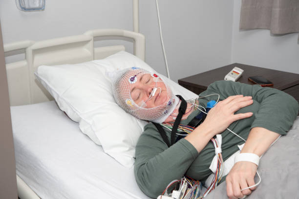 istock Middle aged woman measuring brain waves, examining polysomnography in sleep lab 1482377156