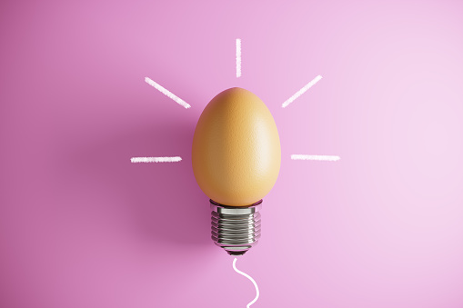 Light bulb shaped of egg on pink background, flat lay. (3d render)