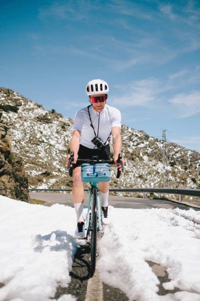 istock Road cyclist rides dividing line on mountain road 1482385004