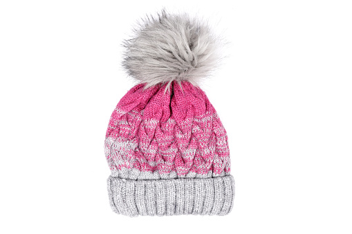 winter pink hat with pompom isolated on white background