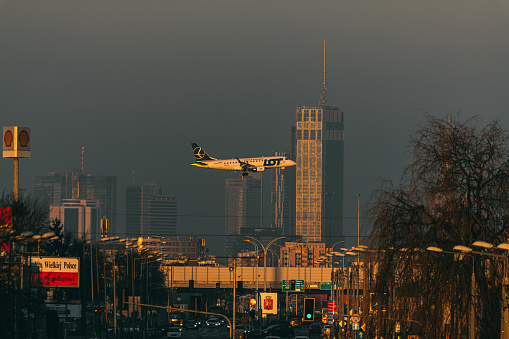 Plane on the background of the city Warsaw. Jan 9 2023, 16:53 Warsaw, Poland. LOT airlines