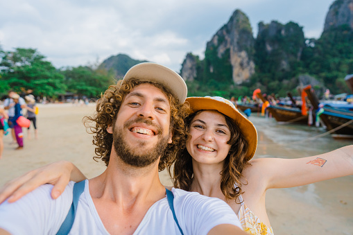 Selfie of young Caucasian woman and man  on the background of  Railey  beach in Krabi, Thailand